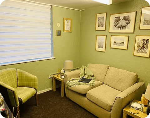 Adult sitting comfortably during a one-to-one counselling session in a welcoming therapy room